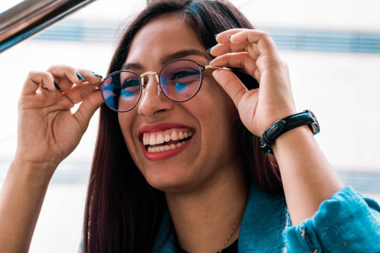 A lady trying on eyeglasses