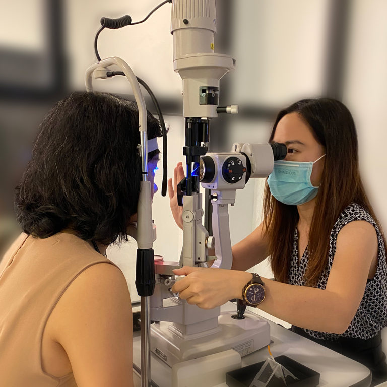 An optometrist performing comprehensive eye examination to check whether the patient has cataract or not..