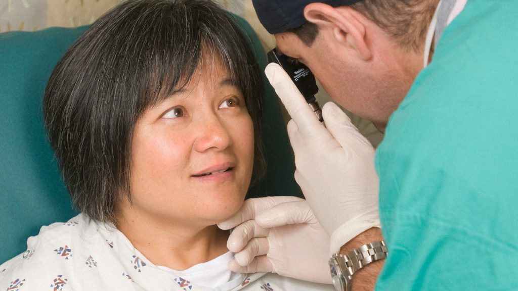 An ophthalmologist performs post operation eye screening